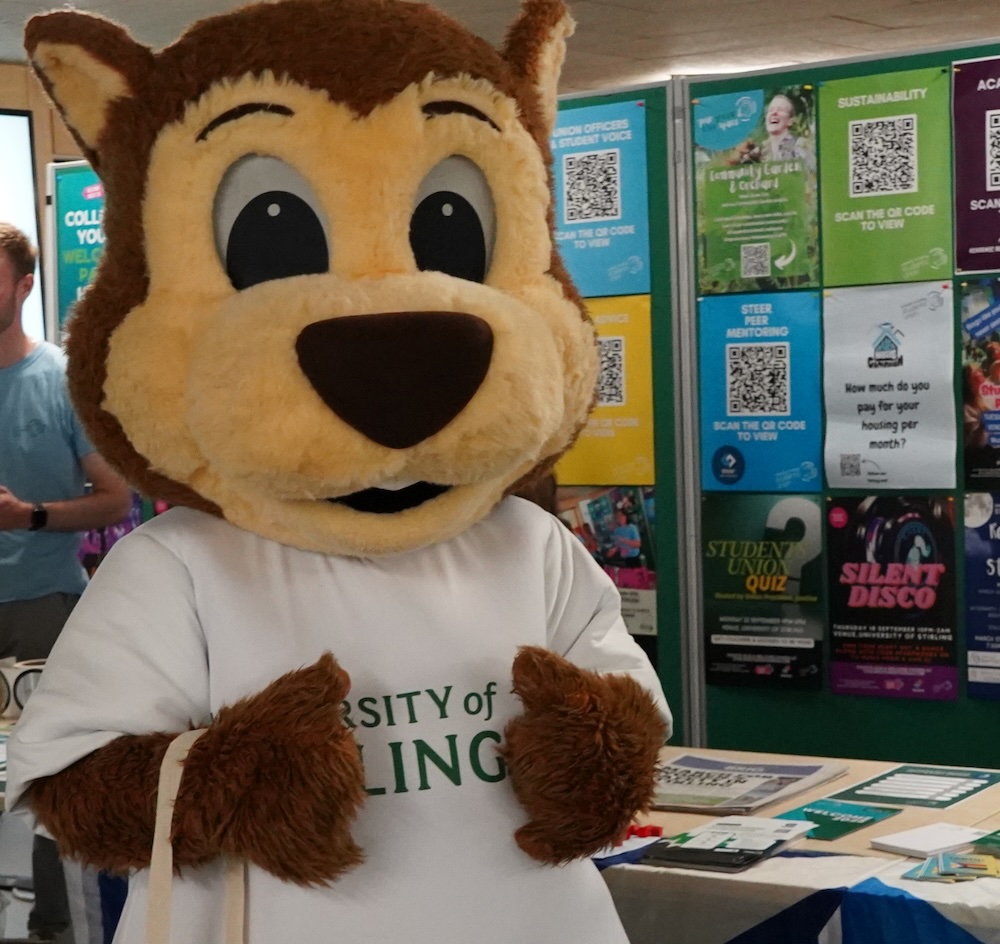 Person in a beaver mascot costume with a University of Stirling Tshirt. 