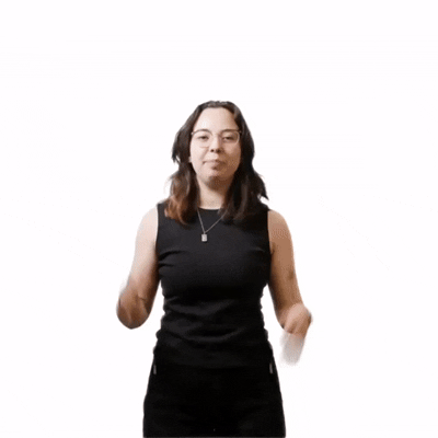 Moving image of a person with shoulder length brown hair waving at the camera.