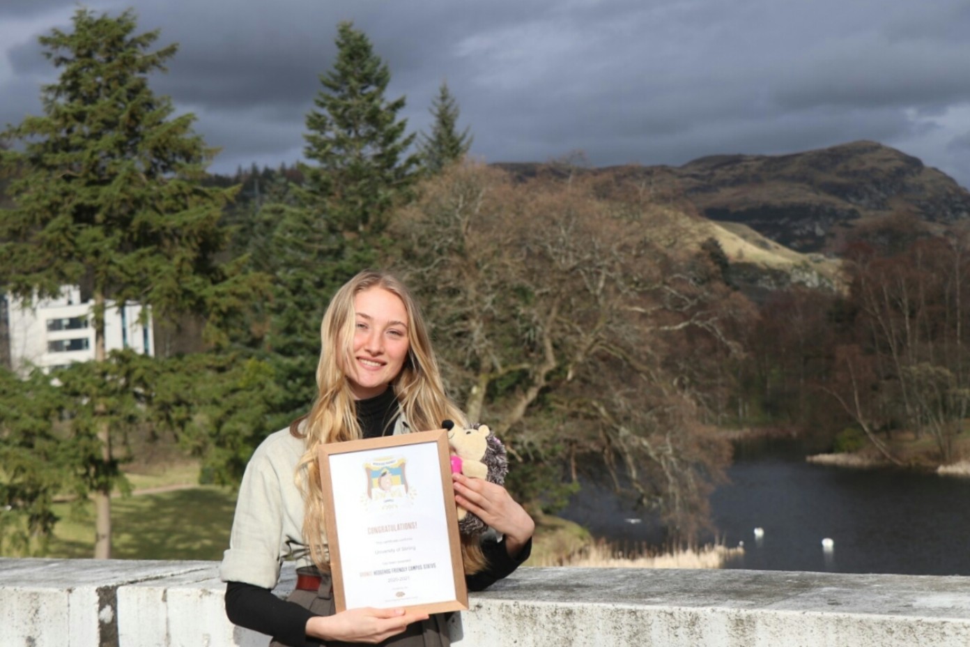 Julia Grootaers, President of the Environmental Enterprise Society with the award on campus. Photo by Louis Ware